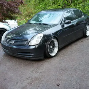 A black car parked on the side of a road.