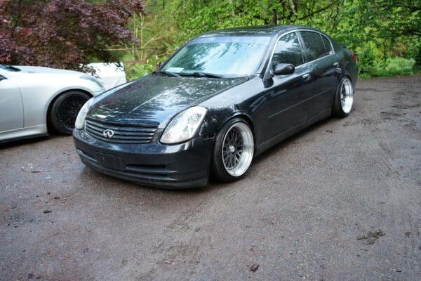 A black car parked on the side of a road.