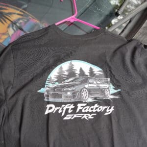 A black shirt with a picture of a car on it.