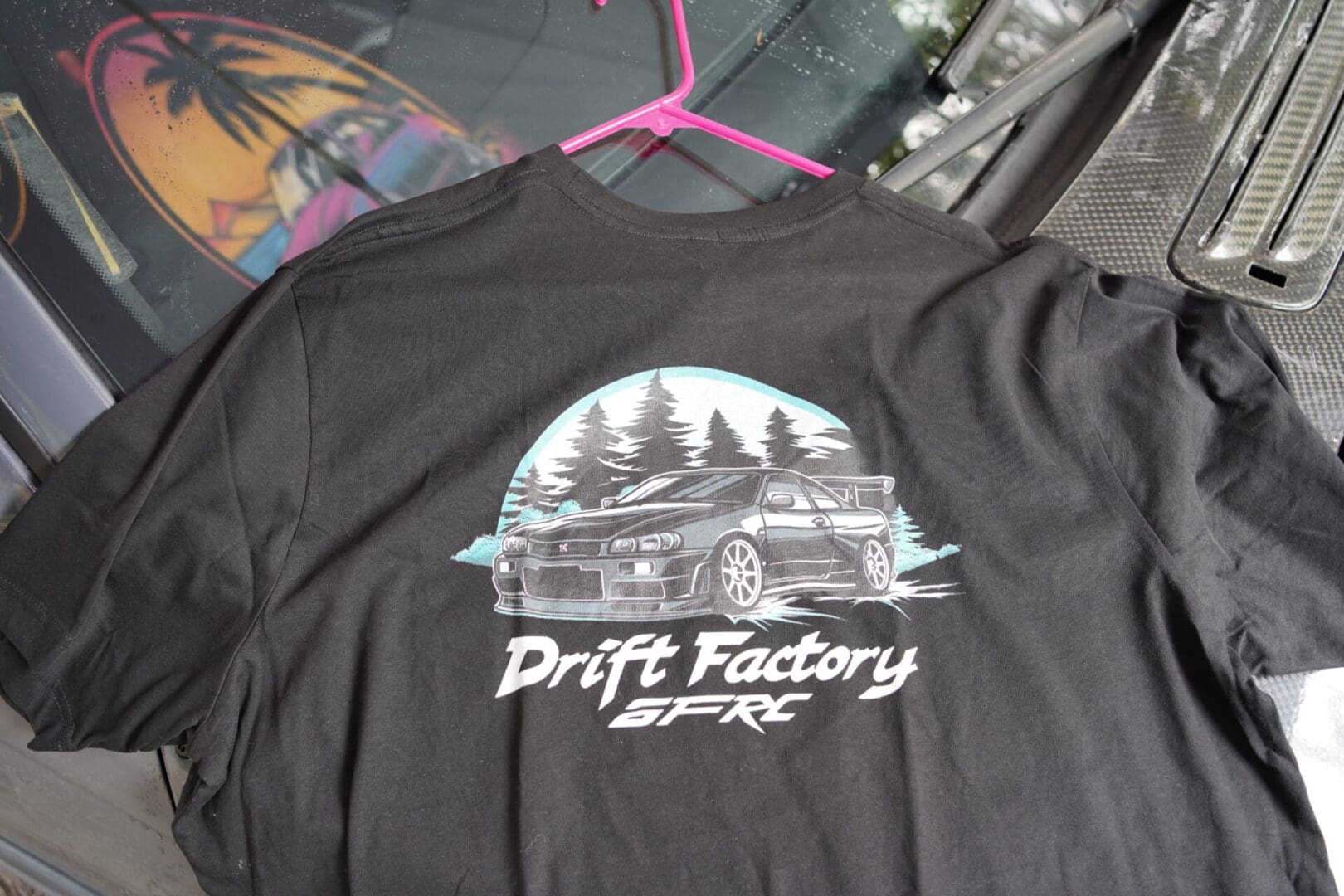 A black shirt with a picture of a car on it.