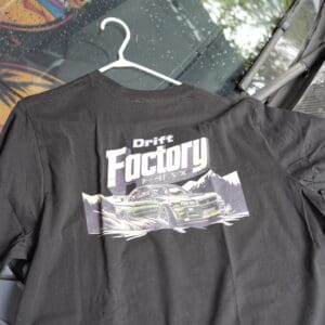 A black shirt with the words " grey factory ".