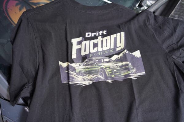 A black shirt with the words drift factory printed on it.