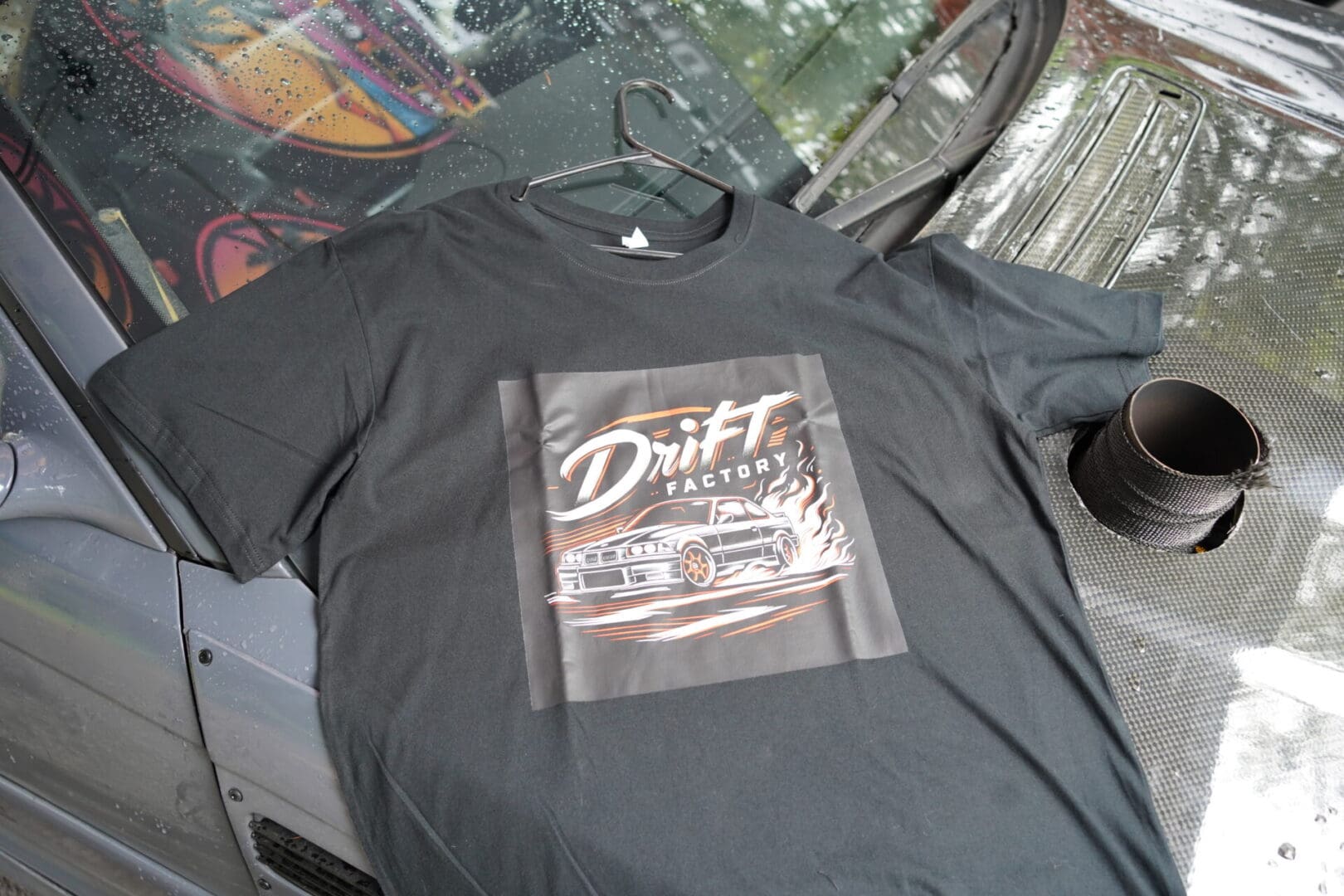 A black shirt with a picture of a car on it.