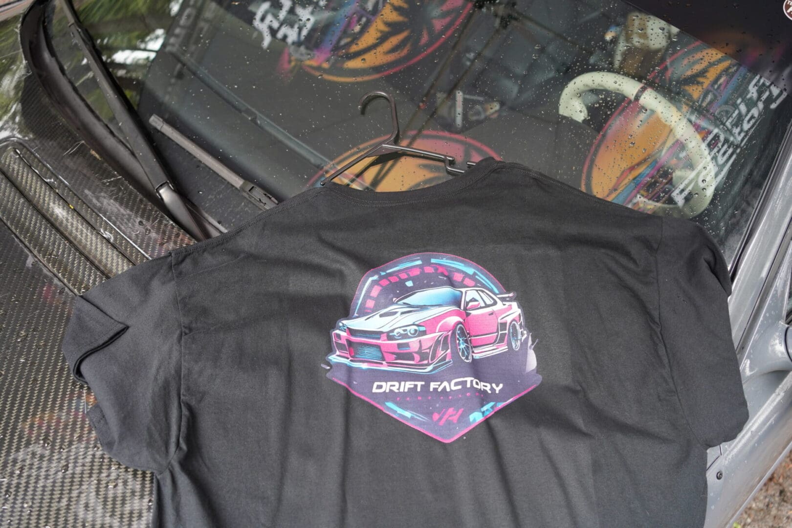 A close up of the back of a shirt with a car on it