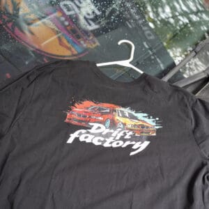 A black shirt with the drift factory logo on it.