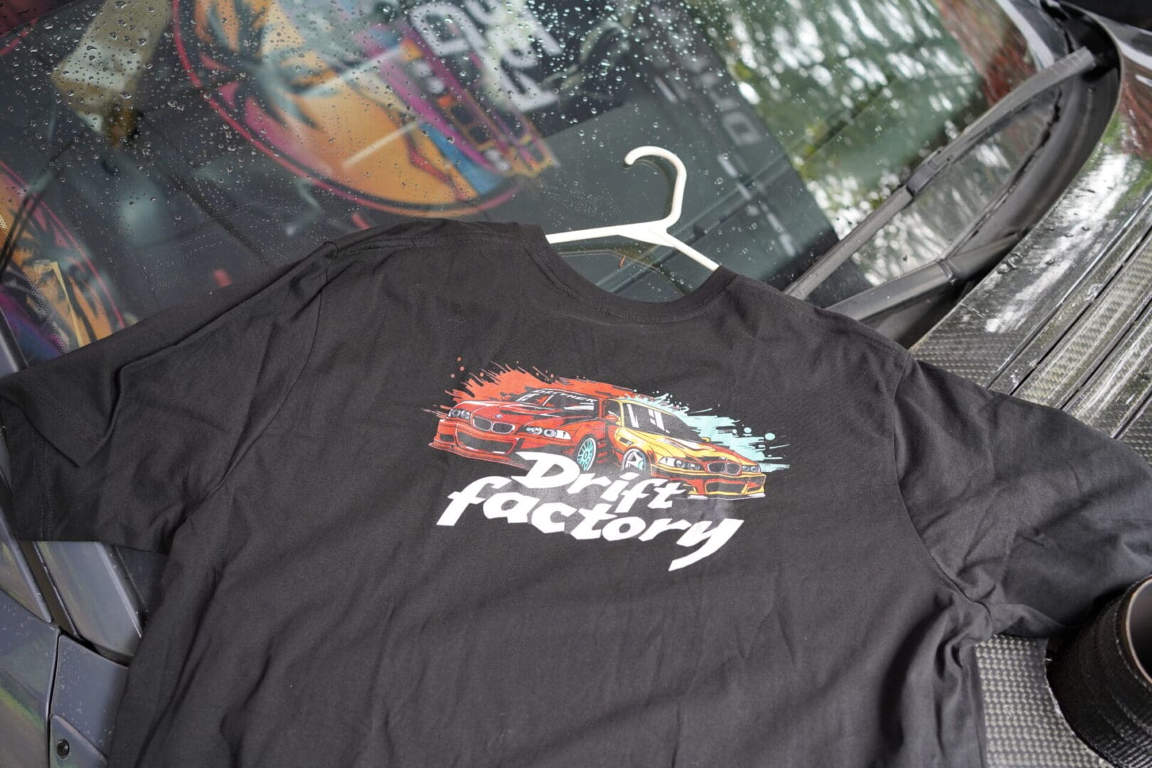 A black shirt with the drift factory logo on it.