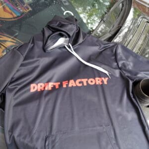 A black hoodie with the words drift factory on it.